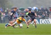 19 April 2025; Barry McNulty of Leitrim is tackled by Mayo players, from left, Jack Carney and Enda Hession, during the Connacht GAA Football Senior Championship semi-final match between Leitrim and Mayo at Avant Money Páirc Seán Mac Diarmada in Carrick-on-Shannon, Leitrim. Photo by Thomas Flinkow/Sportsfile
