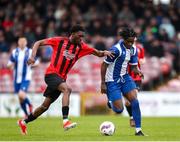 19 April 2025; Destiny Okonkwo of College Corinthians AFC in action against Alan Happi of Ringmahon Rangers FC during the FAI Intermediate Cup final match between College Corinthians AFC and Ringmahon Rangers FC at Turners Cross Stadium in Cork. Photo by Michael P Ryan/Sportsfile