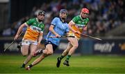 19 April 2025; Brian Hayes of Dublin races clear of Offaly players Cathal King, 8, and Padraig Cantwell during the Leinster GAA Hurling Senior Championship Round 1 match between Dublin and Offaly at Parnell Park in Dublin. Photo by Ray McManus/Sportsfile