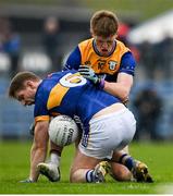 19 April 2025; Paudie Feehan of Tipperary is tackled by Dermot Coughlan of Clare during the Munster GAA Football Senior Championship semi-final match between Clare and Tipperary at Zimmer Biomet Cusack Park in Ennis, Clare. Photo by Tom Beary/Sportsfile
