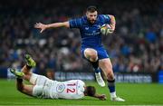 19 April 2025; Robbie Henshaw of Leinster evades the tackle of Stewart Moore of Ulster during the United Rugby Championship match between Leinster and Ulster at the Aviva Stadium in Dublin. Photo by Brendan Moran/Sportsfile
