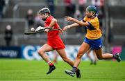 20 April 2025; Niamh Mulqueen of Clare, right, loses her hurl as she attempts to dispossess Saoirse McCarthy of Cork during the Munster Senior Camogie Championship semi-final match between Clare and Cork at Zimmer Biomet Páirc Chíosóg in Ennis, Clare. Photo by Brendan Moran/Sportsfile