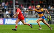 20 April 2025; Amy O'Connor of Cork in action against Abby Walsh of Clare during the Munster Senior Camogie Championship semi-final match between Clare and Cork at Zimmer Biomet Páirc Chíosóg in Ennis, Clare. Photo by Brendan Moran/Sportsfile