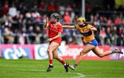 20 April 2025; Amy O'Connor of Cork in action against Abby Walsh of Clare during the Munster Senior Camogie Championship semi-final match between Clare and Cork at Zimmer Biomet Páirc Chíosóg in Ennis, Clare. Photo by Brendan Moran/Sportsfile