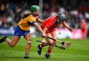 20 April 2025; Amy O'Connor of Cork in action against Susan Daly of Clare during the Munster Senior Camogie Championship semi-final match between Clare and Cork at Zimmer Biomet Páirc Chíosóg in Ennis, Clare. Photo by Brendan Moran/Sportsfile