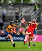 20 April 2025; Ashling Thompson of Cork in action against Sinead O'Keeffe of Clare during the Munster Senior Camogie Championship semi-final match between Clare and Cork at Zimmer Biomet Páirc Chíosóg in Ennis, Clare. Photo by Brendan Moran/Sportsfile