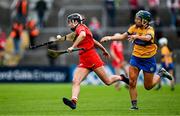 20 April 2025; Niamh Mulqueen of Clare, right, loses her hurl as she attempts to dispossess Saoirse McCarthy of Cork during the Munster Senior Camogie Championship semi-final match between Clare and Cork at Zimmer Biomet Páirc Chíosóg in Ennis, Clare. Photo by Brendan Moran/Sportsfile
