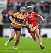20 April 2025; Saoirse McCarthy of Cork is tackled by Clare Hehir of Clare during the Munster Senior Camogie Championship semi-final match between Clare and Cork at Zimmer Biomet Páirc Chíosóg in Ennis, Clare. Photo by Brendan Moran/Sportsfile