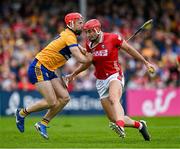 20 April 2025; Brian Hayes of Cork is tackled by Darragh Lohan of Clare during the Munster GAA Hurling Senior Championship Round 1 match between Clare and Cork at Zimmer Biomet Páirc Chíosóg in Ennis, Clare. Photo by Brendan Moran/Sportsfile