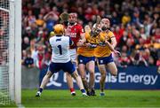 20 April 2025; Brian Hayes of Cork scores his side's first goal past Clare goalkeeper Eibhear Quilligan and Clare players Conor Leen and Darragh Lohan during the Munster GAA Hurling Senior Championship Round 1 match between Clare and Cork at Zimmer Biomet Páirc Chíosóg in Ennis, Clare. Photo by Brendan Moran/Sportsfile