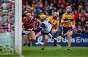 20 April 2025; Brian Hayes of Cork scores his side's first goal past Clare goalkeeper Eibhear Quilligan and Clare players Conor Leen and Darragh Lohan during the Munster GAA Hurling Senior Championship Round 1 match between Clare and Cork at Zimmer Biomet Páirc Chíosóg in Ennis, Clare. Photo by Brendan Moran/Sportsfile