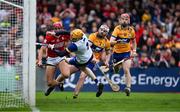 20 April 2025; Brian Hayes of Cork scores his side's first goal past Clare goalkeeper Eibhear Quilligan and Clare players Conor Leen and Darragh Lohan during the Munster GAA Hurling Senior Championship Round 1 match between Clare and Cork at Zimmer Biomet Páirc Chíosóg in Ennis, Clare. Photo by Brendan Moran/Sportsfile