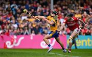 20 April 2025; David Reidy of Clare scores his side's second goal despite the challenge of Robert Downey of Cork during the Munster GAA Hurling Senior Championship Round 1 match between Clare and Cork at Zimmer Biomet Páirc Chíosóg in Ennis, Clare. Photo by Brendan Moran/Sportsfile