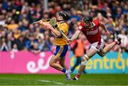 20 April 2025; David Reidy of Clare scores his side's second goal despite the challenge of Robert Downey of Cork during the Munster GAA Hurling Senior Championship Round 1 match between Clare and Cork at Zimmer Biomet Páirc Chíosóg in Ennis, Clare. Photo by Brendan Moran/Sportsfile
