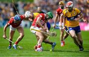 20 April 2025; Brian Roche of Cork battles for possession against Adam Hogan of Clare in injury time during the Munster GAA Hurling Senior Championship Round 1 match between Clare and Cork at Zimmer Biomet Páirc Chíosóg in Ennis, Clare. Photo by John Sheridan/Sportsfile