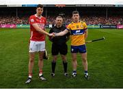 20 April 2025; Robert Downey of Cork shakes hands with Tony Kelly of Clare before the coin toss as referee Liam Gordon looks on before the Munster GAA Hurling Senior Championship Round 1 match between Clare and Cork at Zimmer Biomet Páirc Chíosóg in Ennis, Clare. Photo by John Sheridan/Sportsfile
