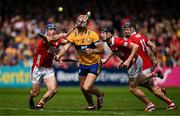 20 April 2025; Peter Duggan of Clare in action against Cork players Seán O’Donoghue, Eoin Downey and Darragh Fitzgibbon during the Munster GAA Hurling Senior Championship Round 1 match between Clare and Cork at Zimmer Biomet Páirc Chíosóg in Ennis, Clare. Photo by Brendan Moran/Sportsfile