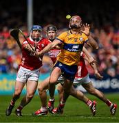 20 April 2025; Peter Duggan of Clare in action against Cork players Seán O’Donoghue, Eoin Downey and Darragh Fitzgibbon during the Munster GAA Hurling Senior Championship Round 1 match between Clare and Cork at Zimmer Biomet Páirc Chíosóg in Ennis, Clare. Photo by Brendan Moran/Sportsfile