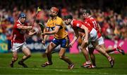 20 April 2025; Peter Duggan of Clare in action against Cork players Seán O’Donoghue, Eoin Downey and Darragh Fitzgibbon during the Munster GAA Hurling Senior Championship Round 1 match between Clare and Cork at Zimmer Biomet Páirc Chíosóg in Ennis, Clare. Photo by Brendan Moran/Sportsfile