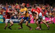 20 April 2025; Peter Duggan of Clare in action against Cork players Seán O’Donoghue, Eoin Downey and Darragh Fitzgibbon during the Munster GAA Hurling Senior Championship Round 1 match between Clare and Cork at Zimmer Biomet Páirc Chíosóg in Ennis, Clare. Photo by Brendan Moran/Sportsfile