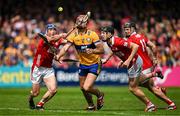 20 April 2025; Peter Duggan of Clare in action against Cork players Seán O’Donoghue, Eoin Downey and Darragh Fitzgibbon during the Munster GAA Hurling Senior Championship Round 1 match between Clare and Cork at Zimmer Biomet Páirc Chíosóg in Ennis, Clare. Photo by Brendan Moran/Sportsfile