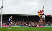 20 April 2025; Brian Hayes of Cork attempts to palm the sliotar to the net as he is tackled by Darragh Lohan of Clare during the Munster GAA Hurling Senior Championship Round 1 match between Clare and Cork at Zimmer Biomet Páirc Chíosóg in Ennis, Clare. Photo by Brendan Moran/Sportsfile