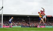 20 April 2025; Brian Hayes of Cork attempts to palm the sliotar to the net as he is tackled by Darragh Lohan of Clare during the Munster GAA Hurling Senior Championship Round 1 match between Clare and Cork at Zimmer Biomet Páirc Chíosóg in Ennis, Clare. Photo by Brendan Moran/Sportsfile