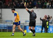 19 April 2025; Referee James Molloy shows a yellow card to Aaron Griffin of Clare during the Munster GAA Football Senior Championship semi-final match between Clare and Tipperary at Zimmer Biomet Cusack Park in Ennis, Clare. Photo by Tom Beary/Sportsfile