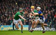 20 April 2025; Bryan O'Mara of Tipperary in action against Limerick players William O’Donoghue, left, and Tom Morrissey during the Munster GAA Hurling Senior Championship Round 1 match between Tipperary and Limerick at FBD Semple Stadium in Thurles, Tipperary. Photo by Seb Daly/Sportsfile