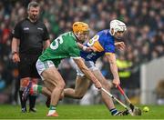 20 April 2025; Craig Morgan of Tipperary in action against Adam English of Limerick during the Munster GAA Hurling Senior Championship Round 1 match between Tipperary and Limerick at FBD Semple Stadium in Thurles, Tipperary. Photo by Seb Daly/Sportsfile