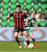 21 April 2025; James Clarke of Bohemians in action against Lee Grace of Shamrock Rovers during the SSE Airtricity Men's Premier Division match between Shamrock Rovers and Bohemians at Tallaght Stadium in Dublin. Photo by Stephen McCarthy/Sportsfile