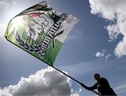 21 April 2025; A Cork City supporter prepares a flag for a display before the SSE Airtricity Men's Premier Division match between Cork City and Waterford at Turners Cross in Cork. Photo by Seb Daly/Sportsfile