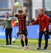21 April 2025; Niall Morahan of Bohemians takes a throw-in as Bohemians manager Alan Reynolds watches on during the SSE Airtricity Men's Premier Division match between Shamrock Rovers and Bohemians at Tallaght Stadium in Dublin. Photo by Stephen McCarthy/Sportsfile