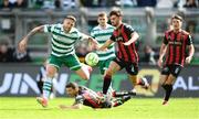 21 April 2025; Lee Grace of Shamrock Rovers in action against Niall Morahan, right, and Keith Buckley of Bohemians during the SSE Airtricity Men's Premier Division match between Shamrock Rovers and Bohemians at Tallaght Stadium in Dublin. Photo by Stephen McCarthy/Sportsfile