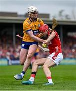 20 April 2025; Alan Connolly of Cork is tackled by Adam Hogan of Clare during the Munster GAA Hurling Senior Championship Round 1 match between Clare and Cork at Zimmer Biomet Páirc Chíosóg in Ennis, Clare. Photo by Brendan Moran/Sportsfile