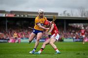 20 April 2025; Alan Connolly of Cork is tackled by Adam Hogan of Clare during the Munster GAA Hurling Senior Championship Round 1 match between Clare and Cork at Zimmer Biomet Páirc Chíosóg in Ennis, Clare. Photo by Brendan Moran/Sportsfile