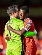 21 April 2025; Mipo Odubeko of Shelbourne and Galway United goalkeeper Brendan Clarke share a joke after the SSE Airtricity Men's Premier Division match between Shelbourne and Galway United at Tolka Park in Dublin. Photo by Sam Barnes/Sportsfile