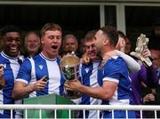 19 April 2025; College Corinthians AFC captain Craig Donnellan, right, celebrates with teammates after collecting the cup after the FAI Intermediate Cup final match between College Corinthians AFC and Ringmahon Rangers FC at Turners Cross Stadium in Cork. Photo by Michael P Ryan/Sportsfile