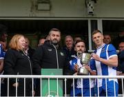19 April 2025; FAI vice-president John Finnegan presents the cup to College Corinthians AFC captain Craig Donnellan after the FAI Intermediate Cup final match between College Corinthians AFC and Ringmahon Rangers FC at Turners Cross Stadium in Cork. Photo by Michael P Ryan/Sportsfile
