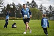 22 April 2025; Galway Footballer and Kellogg’s GAA Cúl Camps ambassador Damien Comer with Lev Dedenko at Kellogg’s Cúl and Curious camp in St Breckan’s GAA in Lisdoonvarna. The Cúl and Curious camp saw children from migrant families invited to take part in a unique introductory Kellogg’s GAA Cúl Camps experience, sharing the fun with local Irish children and fostering a strong sense of community spirit. Kellogg's worked closely with the GAA and Clare Sports Partnership to create the bespoke Kellogg’s GAA Cúl Camp which saw 100 children take part. Photo by Sam Barnes/Sportsfile