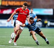 25 April 2025; Tom Farrell of Munster and Liam Belcher of Cardiff go for the ball during the United Rugby Championship match between Cardiff and Munster at Cardiff Arms Park in Cardiff, Wales. Photo by Chris Fairweather/Sportsfile