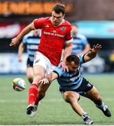 25 April 2025; Tom Farrell of Munster and Liam Belcher of Cardiff go for the ball during the United Rugby Championship match between Cardiff and Munster at Cardiff Arms Park in Cardiff, Wales. Photo by Chris Fairweather/Sportsfile