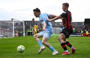 25 April 2025; Axel Sjoberg of St Patrick's Athletic in action against Rhys Brennan of Bohemians during the SSE Airtricity Men's Premier Division match between Bohemians and St Patrick's Athletic at Dalymount Park in Dublin. Photo by Seb Daly/Sportsfile