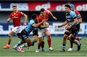 25 April 2025; Tom Farrell of Munster is tackled by Ben Thomas of Cardiff during the United Rugby Championship match between Cardiff and Munster at Cardiff Arms Park in Cardiff, Wales. Photo by Chris Fairweather/Sportsfile