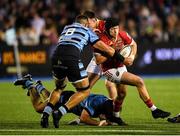 25 April 2025; Mike Haley of Munster is challenged by Taulupe Faletau of Cardiff during the United Rugby Championship match between Cardiff and Munster at Cardiff Arms Park in Cardiff, Wales. Photo by Kian Abdullah/Sportsfile