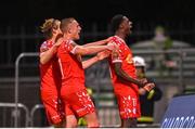 25 April 2025; Mipo Odubeko of Shelbourne celebrates with team-mates Harry Wood, left, and Evan Caffrey after scoring their side's second goal during the SSE Airtricity Men's Premier Division match between Shamrock Rovers and Shelbourne at Tallaght Stadium in Dublin. Photo by Ramsey Cardy/Sportsfile