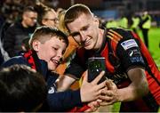 25 April 2025; Ross Tierney of Bohemians takes a selfie with supporters after the SSE Airtricity Men's Premier Division match between Bohemians and St Patrick's Athletic at Dalymount Park in Dublin. Photo by Seb Daly/Sportsfile