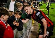 25 April 2025; Ross Tierney of Bohemians takes a selfie with supporters after the SSE Airtricity Men's Premier Division match between Bohemians and St Patrick's Athletic at Dalymount Park in Dublin. Photo by Seb Daly/Sportsfile