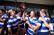 26 April 2025; Athy captain Niamh Goggin, centre, celebrates with her teammates and the Plate after the Flood Plate Final match between Athy and UCD during the Leinster Rugby Girls Finals Day at Mullingar RFC in Mullingar, Westmeath. Photo by Ben McShane/Sportsfile