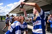 26 April 2025; Julie Nolan of Athy, right, celebrates by pouring champagne into the mouths of her teammates Shauna Healy, left, and Amy Lynch after the Flood Plate Final match between Athy and UCD during the Leinster Rugby Girls Finals Day at Mullingar RFC in Mullingar, Westmeath. Photo by Ben McShane/Sportsfile